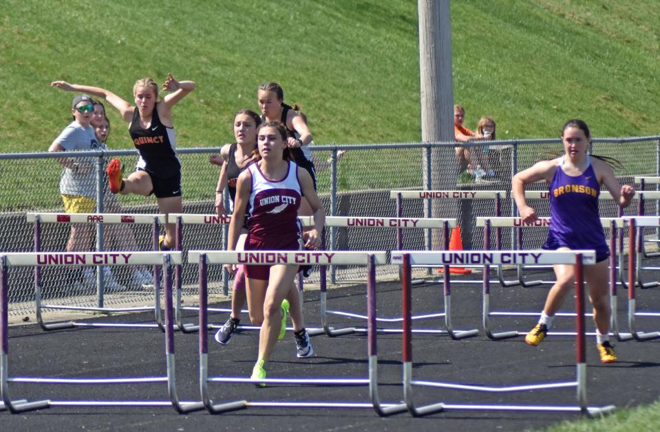 Union City's Nevada Gillons leads the pack during the 100 meter hurdles on Saturday. Also pictured a runners in the top three including Quincy's Brookelyn Parker and Bronson's Jaiden Hayes