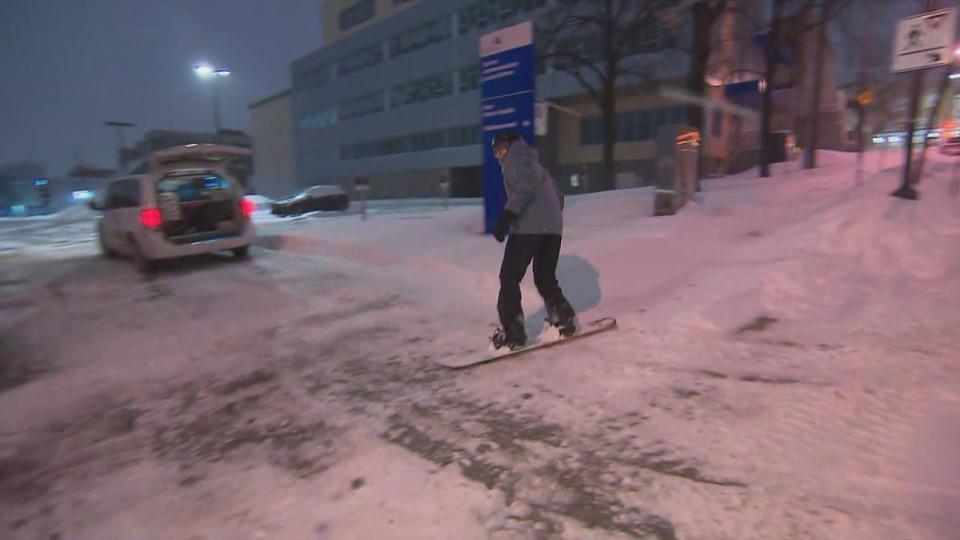 Some people took advantage of the snowfall to snowboard down the sidewalks of Quebec City early Wednesday morning. 