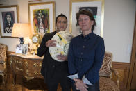 FILE - Marina Picasso, right, granddaughter of artist Pablo Picasso, and her son Florian Picasso pose with a ceramic art-work of Pablo Picasso in Cologny near in Geneva, Switzerland, Tuesday, Jan. 25, 2022. The pair told The Associated Press that they planned to sell 1,010 digital art pieces of one of his ceramic works that has never before seen publicly but a lawyer for the late artist says no sale of digital Picasso art has not been permitted and no digital Picasso artwork would be sold. (AP Photo/Boris Heger, File)