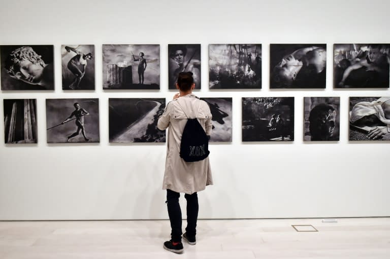 A visitor admires "The Greek way", by Polish-US artist Piotr Uklanski and US artists McDermott & McGough ahead of the public opening of the Documenta 14 art exhibition in Athens