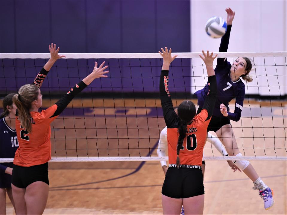 Wylie's Aliyah Jowers, right, hits the ball as Llano's Jayme Duroy (10) and Madi Green (2) defend. Wylie beat Llano 25-11, 25-11 in pool play at the Bev Ball Classic on Friday at Bulldog Gym.