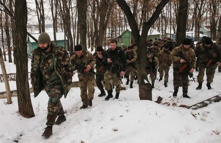 Pro-Russian separatists from the Chechen "Death" battalion walk during a training exercise in the territory controlled by the self-proclaimed Donetsk People's Republic, eastern Ukraine, December 8, 2014. REUTERS/Maxim Shemetov
