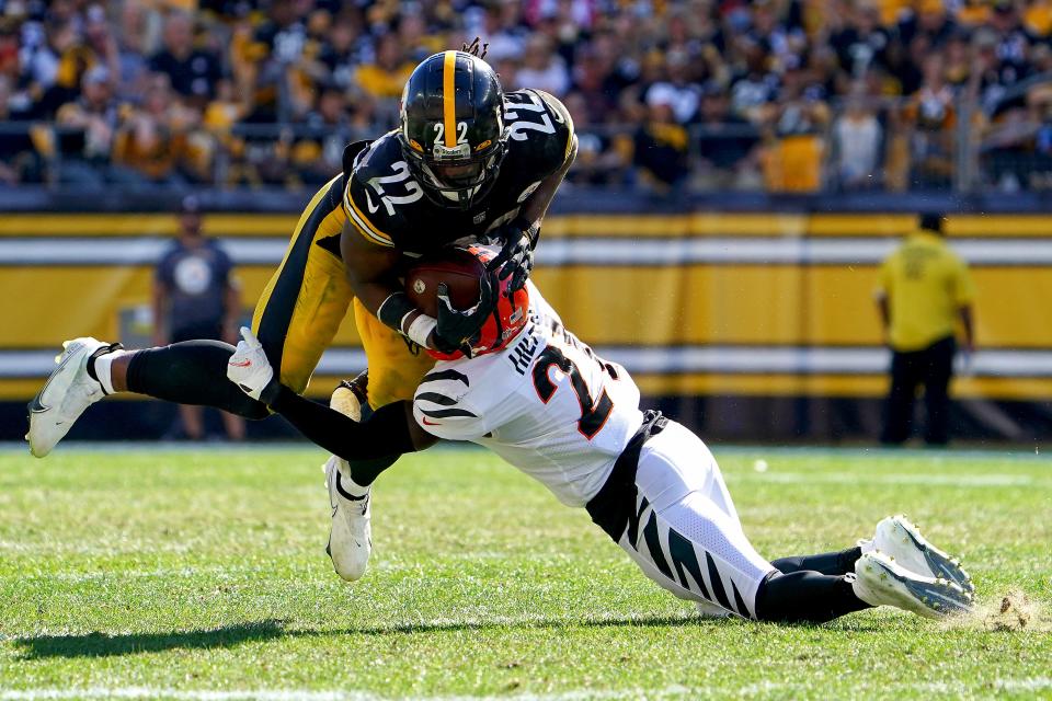 Cincinnati Bengals cornerback Mike Hilton (21) tackles Pittsburgh Steelers running back Najee Harris (22) in the fourth quarter during a Week 3 NFL football game, Sunday, Sept. 26, 2021, at Heinz Field in Pittsburgh.