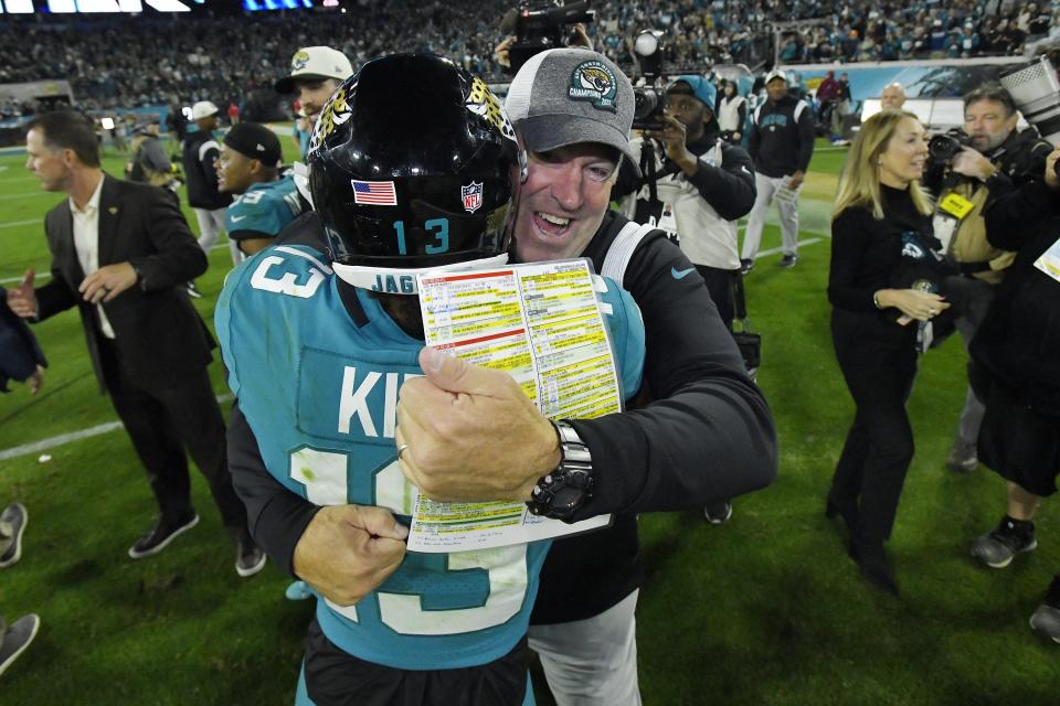 Jacksonville Jaguars head coach Doug Pederson hugs wide receiver Christian Kirk (13) after Saturday night's victory over the Tennessee Titans.