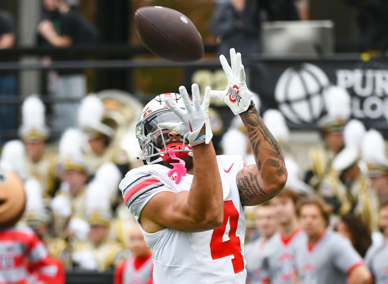 Ohio State wide receiver Julian Fleming catches a pass during warmups prior to the game against Purdue.