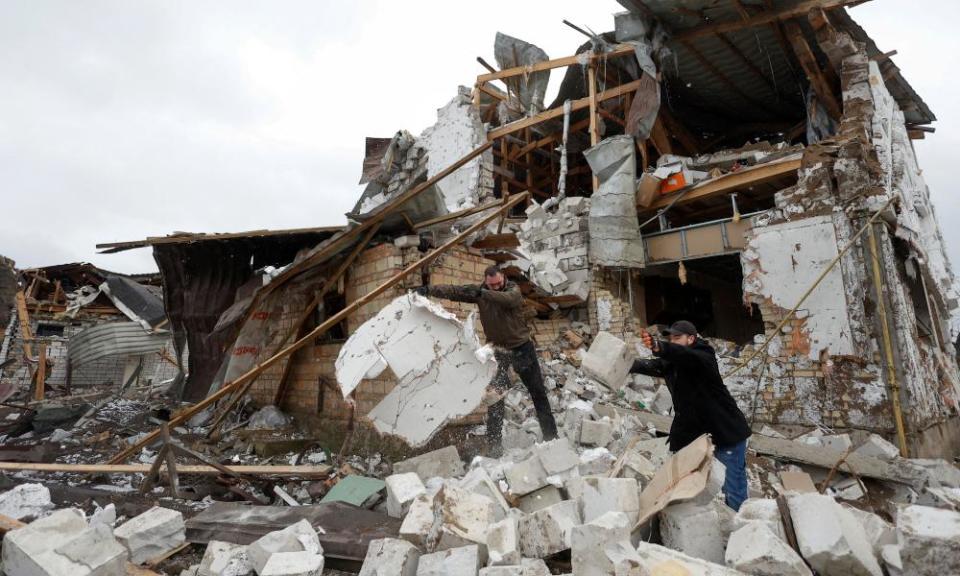 Local residents remove debris from a house of their neighbour damaged by a Russian military strike, amid Russia’s attack on Ukraine, in the town of Hlevakha, outside Kyiv, on 26 January 2023.