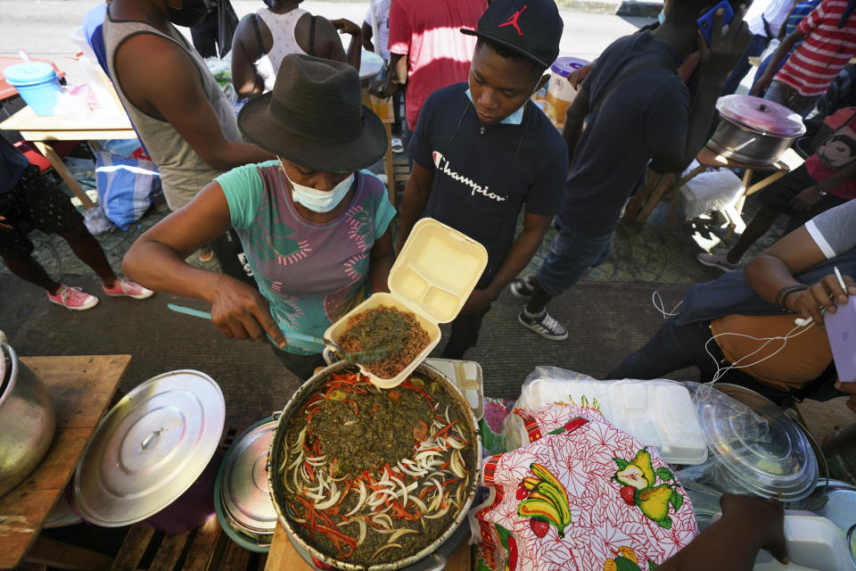 FILE - In this Sept. 3, 2021 file photo, a Haitian vendor sells traditional food outside a market in Tapachula, Mexico. Thousands of mostly Haitian migrants have been stuck in the southern city of Tapachula, many waiting here for months and some up to a year for asylum requests to be processed. (AP Photo/Marco Ugarte, File)