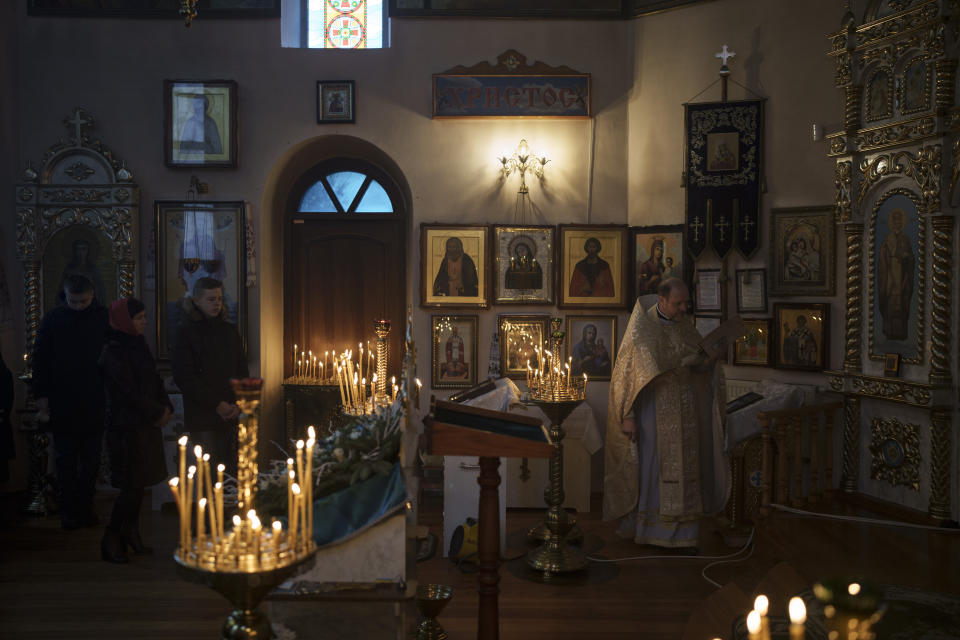 Ukrainians attend a Christmas mass at an Orthodox Church in Bobrytsia, outskirts of Kyiv, Ukraine, Sunday, Dec. 25, 2022. Sunday began with the sound of sirens, but that didn't prevent people from gathering in the church and attend for the first time a Christmas mass on Dec. 25. (AP Photo/Felipe Dana)