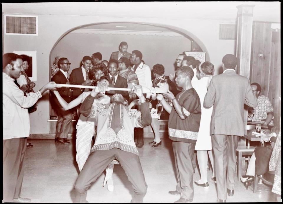 Members of Excelsior Club do the limbo in this undated photo. 