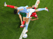 Spain's Marco Asensio, top, and Morocco's Nayef Aguerd challenge for the ball during the World Cup round of 16 soccer match between Morocco and Spain, at the Education City Stadium in Al Rayyan, Qatar, Tuesday, Dec. 6, 2022. (AP Photo/Petr David Josek)