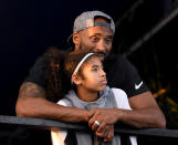 Kobe Bryant and daughter Gianna Bryant watch during day 2 of the Phillips 66 National Swimming Championships at the Woollett Aquatics Center on July 26, 2018 in Irvine, California. (Photo by Harry How/Getty Images)