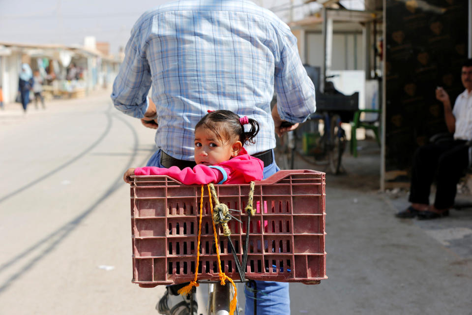 <p>A Syrian refugee rides a bicycle with his daughter at the main market, in the Al-Zaatri refugee camp in the Jordanian city of Mafraq, Jordan, near the border with Syria on Sept. 17, 2016. (Photo: Muhammad Hamed/Reuters) </p>