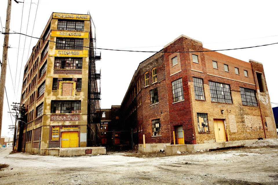 run down buildings with empty parking lots and faded signs