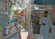 <p>An Afghan shopkeeper looks at broken glass at the site of a suicide attack outside a bank near the US embassy in Kabul on Aug. 29, 2017. (Photo: Shah Marai/AFP/Getty Images) </p>