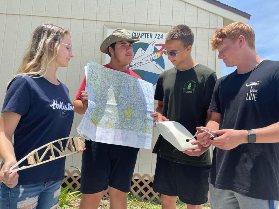 Sophia Sutton, 15, Nathan Lehmann, 15, Gareth Clay, 16, and Landon Forehand, 17, stand outside the Merritt Island Airport bungalow Sunday where they participated in the EAA Young Eagles summer program.