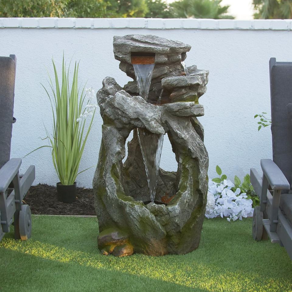 the rainforest water fountain with moss in a yard