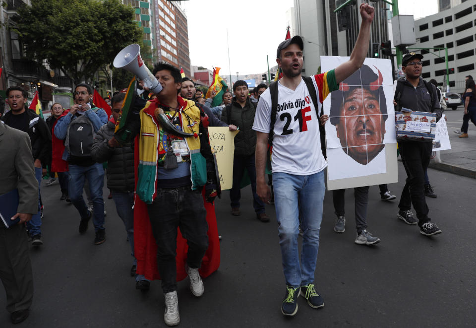 Anti-government protesters hold a picture of Bolivia's President Evo Morales, during a march demanding a second round presidential election, in La Paz, Bolivia, Saturday, Oct. 26, 2019. Bolivia's official vote tally was revealed Friday pointing to an outright win for incumbent Evo Morales in a disputed presidential election that has triggered protests and growing international pressure on the Andean nation to hold a runoff ballot. (AP Photo/Juan Karita)