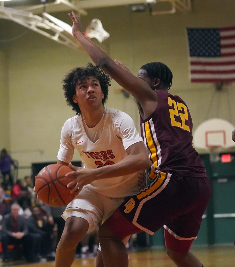 Mamaroneck's Cosmo Hardinson (20) drives on Mount Vernon's Justin Muhammad (22) during boys basketball at Mamaroneck High School on Tuesday, Jan. 23, 2024. Mamaroneck won 72-61.