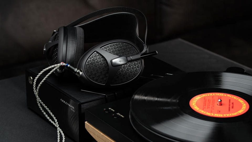 Meze Audio's Empyrean II headphones next to a turntable with a record.