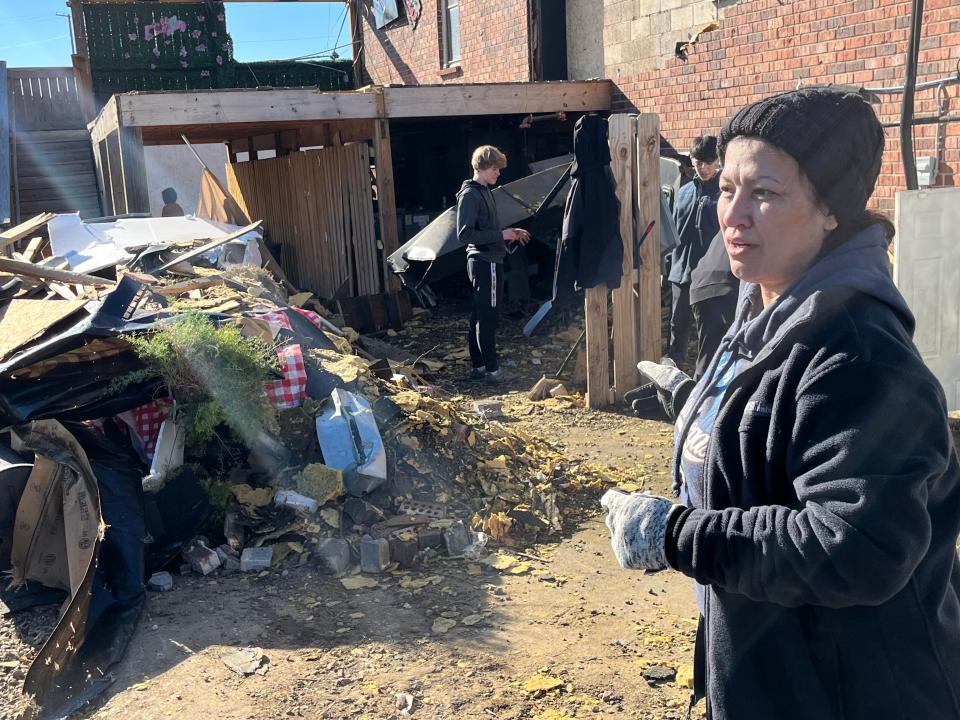 Dilya Knight cleaning up debris and rubble from a tornado that hit Jolly Ollie's Pizza and Pub in Hendersonville along with many other businesses in the city.