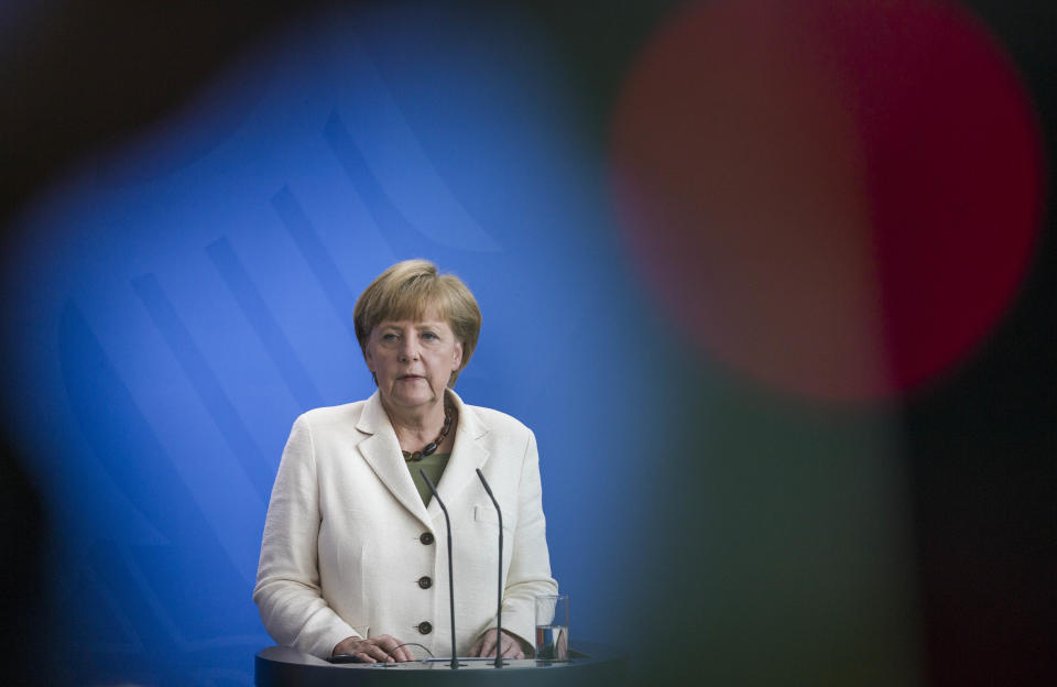 German Chancellor Angela Merkel talks to the media before talks with Poland's Prime Minister Donald Tusk, at the chancellery in Berlin, Germany, Friday, April 25, 2014. (AP Photo/Gero Breloer)