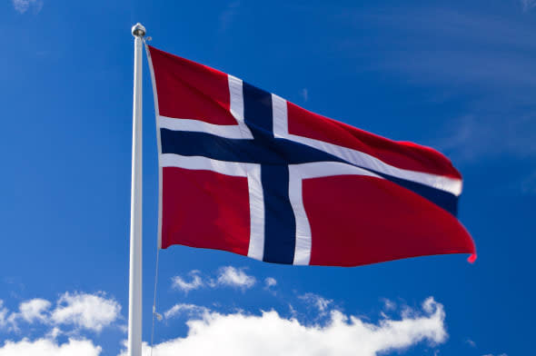 norwegian flag on blue sky and...