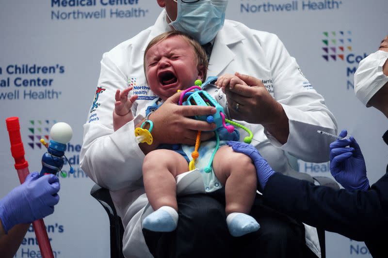 FILE PHOTO: Oliver Harris, 9 months, cries after receiving a vaccine against the coronavirus disease (COVID-19) at Northwell Health's Cohen Children's Medical Center in New Hyde Park, New York