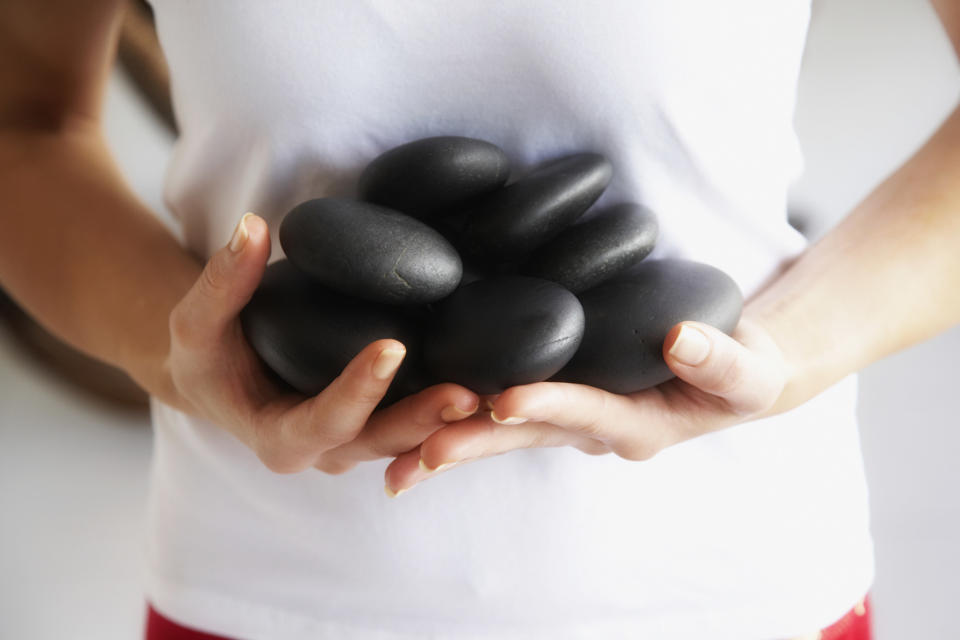 hands holding hot stones