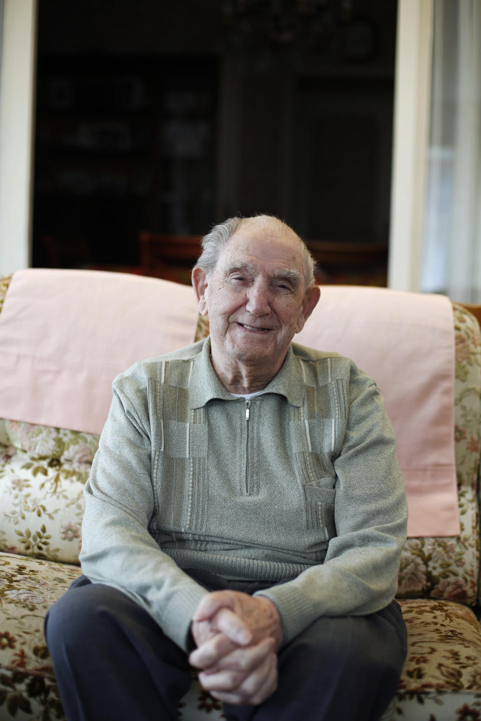 In this photo made May 9, 2019, French World War II veteran Leon Gautier poses for a picture in his house, in Ouistreaham, Normandy. His memories of the war are as vivid as ever. “War is ugly. War is misery,” he says. He wants younger generations to never forget that. (AP Photo/Thibault Camus)