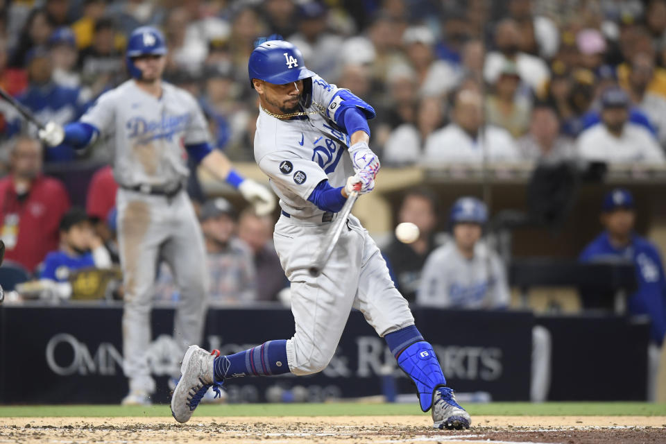 Los Angeles Dodgers' Mookie Betts hits a solo home run during the third inning of a baseball game against the San Diego Padres, Monday, June 21, 2021, in San Diego. (AP Photo/Denis Poroy)