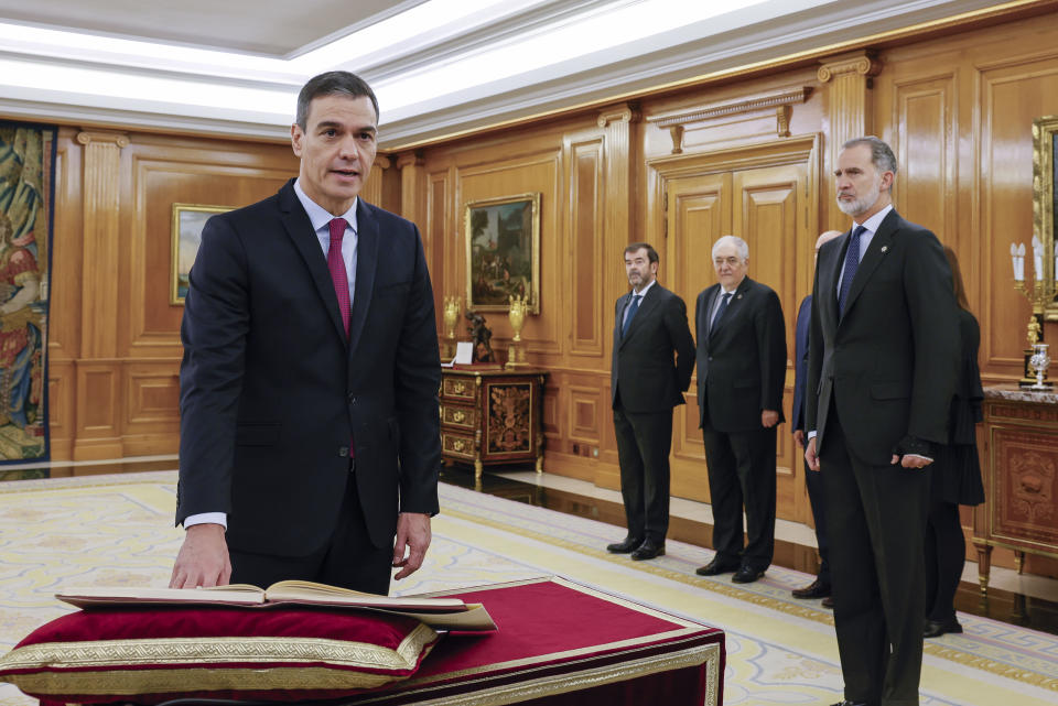 Spanish Socialist leader Pedro Sanchez takes his oath of office watched by Spain's King Felipe, right, during the swearing in ceremony at the Zarzuela Palace just outside of Madrid, Spain, Nov. 17, 2023. Sanchez has taken the oath after winning a parliamentary vote to form a new government centering almost entirely on an amnesty deal for Catalonia's separatists that secured Sanchez's vital support. (Ballesteros/Pool Photo via AP)