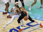 Syracuse's Emily Engstler, right, handles the ball as Louisville's Ahlana Smith, left, defends during the first half of an NCAA college basketball game in the semifinals of Atlantic Coast Conference tournament in Greensboro, N.C., Saturday, March 6, 2021. (AP Photo/Ben McKeown)