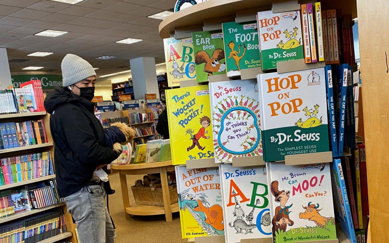  A customer looks at books by Dr. Seuss in a bookstore in Brooklyn, New York, U.S., March 2, 2021 - Brendan McDermid/Reuters