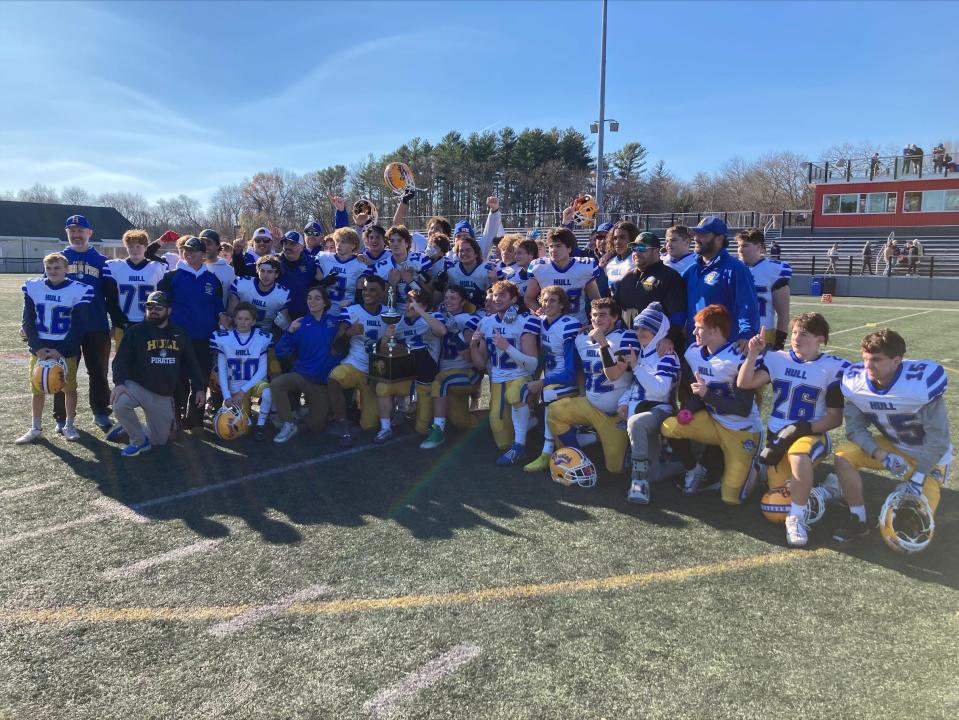 The Hull High football team celebrates its 24-10 Thanksgiving win over Cohasset on Thursday, Nov. 24, 2022.