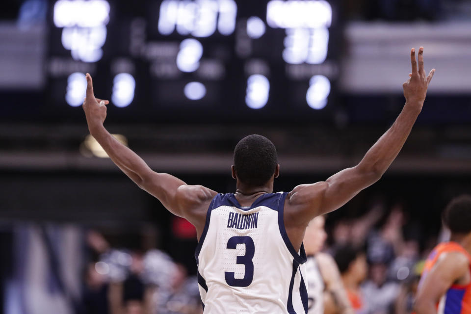 Butler guard Kamar Baldwin (3) celebrates a 3-point basket against Florida in the second half of an NCAA college basketball game in Indianapolis, Saturday, Dec. 7, 2019. Butler defeated Florida 76-62. (AP Photo/Michael Conroy)