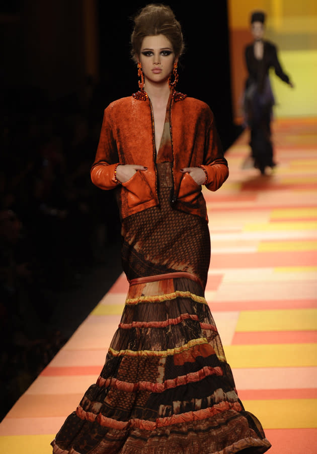 <b>Jean Paul Gaultier SS13 </b><br><br>Dresses featured ruffled hems in burnt orange shades.<br><br>© Rex