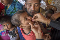 <p>A Bangladeshi health worker administers vaccine to a Rohingya Muslim boy, who crossed over from Myanmar into Bangladesh, at Balukhali refugee camp, Bangladesh, Sunday, Sept. 17, 2017. (Photo: Dar Yasin/AP) </p>