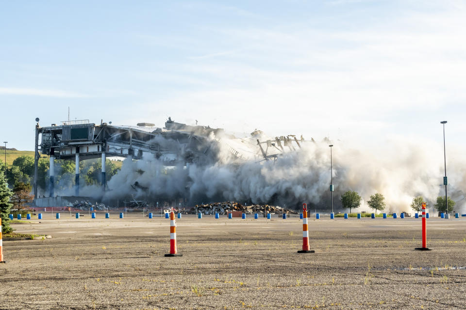 The Palace of Auburn Hills undergoes a controlled demolition in Auburn Hills, Mich., on Saturday, July 11, 2020. Opened in 1988, the multi-use stadium was the home of the Detroit Pistons as well as numerous concerts and sporting events. (David Guralnick/Detroit News via AP)