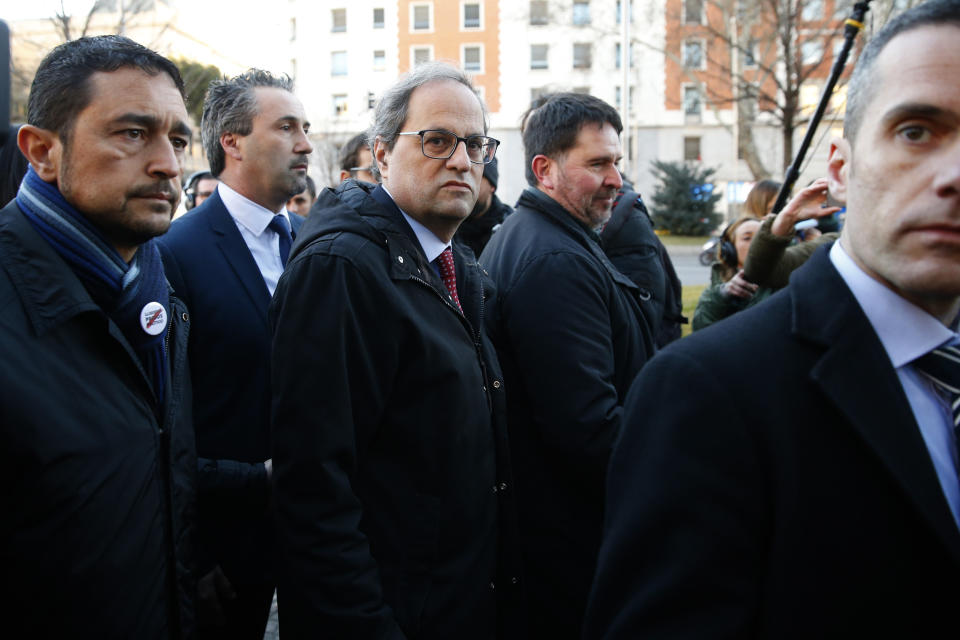 Catalan regional President Quim Torra, centre, arrives at the Spanish Supreme Court in Madrid, Tuesday, Feb. 12, 2019. Spain is bracing for the nation's most sensitive trial in four decades of democracy this week, with a dozen Catalan separatists facing charges including rebellion over a failed secession bid in 2017. (AP Photo/Andrea Comas)