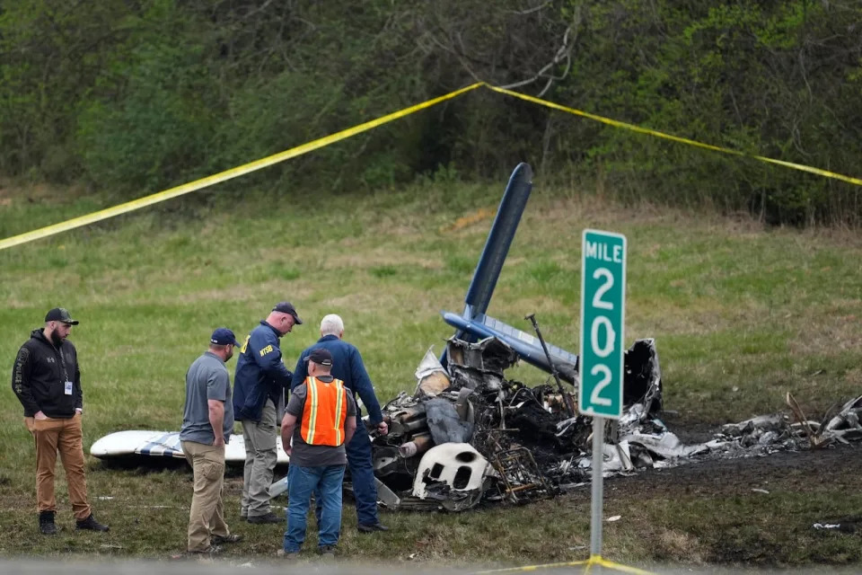 Investigators look over a small plane crash alongside eastbound Interstate 40 at mile marker 202 on Tuesday, March 5, 2024, in Nashville, Tenn. 