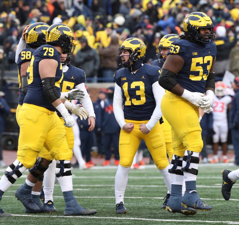 Michigan Wolverines kicker Jake Moody (13) celebrates after kicking the winning field goal against Illinois to seal a 19-17 win at Michigan Stadium, Saturday, Nov. 19, 2022.