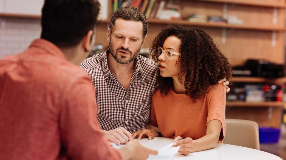 Couple consulting with insurance agent.