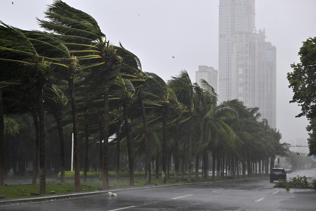 In this photo released by Xinhua News Agency, a vehicle moves past trees along a road in Haikou following the landfall of typhoon Yagi, in south China's Hainan Province, Friday, Sept. 6, 2024. (Guo Cheng/Xinhua via AP)