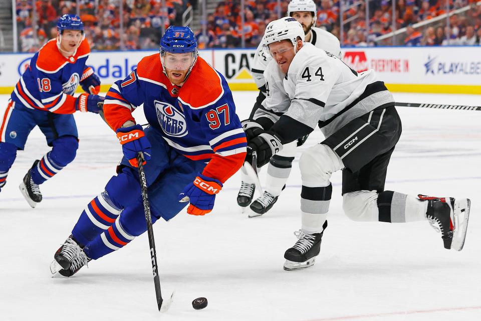 Edmonton Oilers forward Connor McDavid (97) carries the puck around Los Angeles Kings defensemen Mikey Anderson (44) during the first period in game one of the first round of the 2024 Stanley Cup Playoffs at Rogers Place.