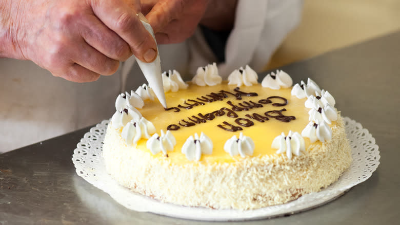 Baker writing message on cake