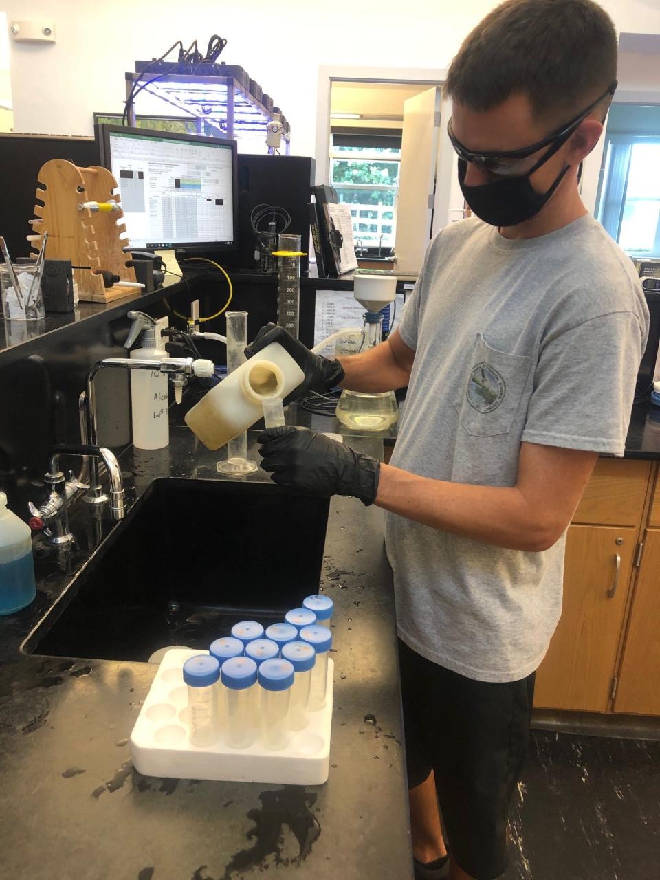 Danny Tomasello, a laboratory technician at the Loxahatchee River Environmental Control District, processes a wastewater sample for delivery to Biobot.