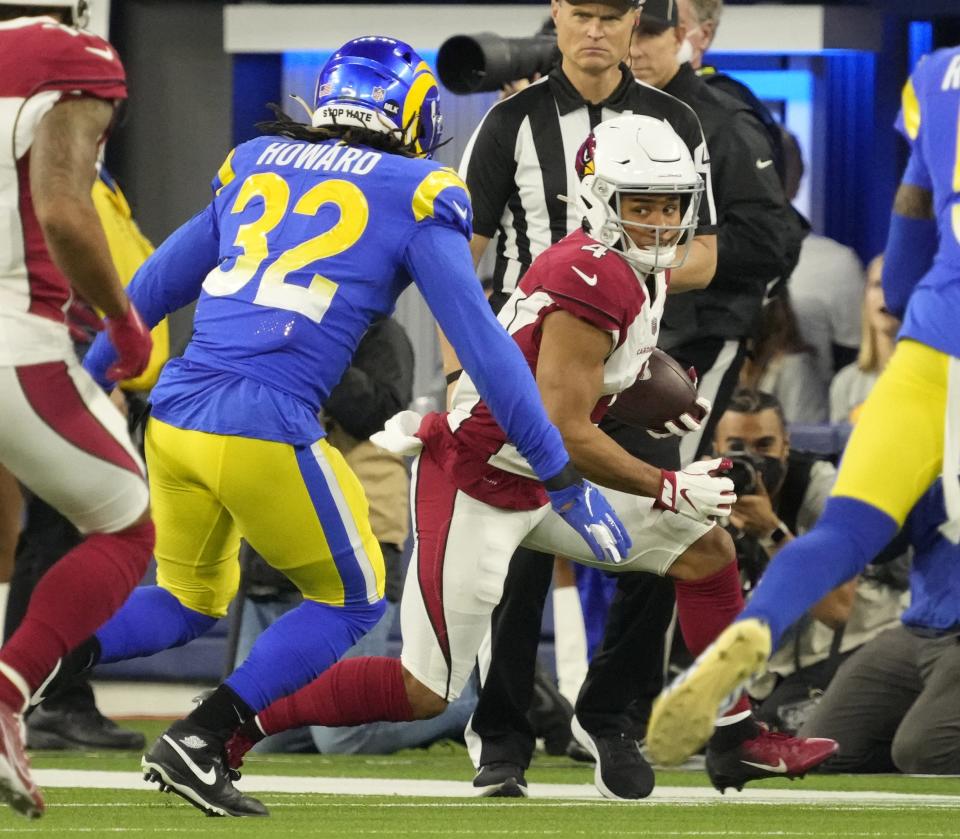 Jan 17, 2022; Los Angeles, California, USA;  Arizona Cardinals wide receiver Rondale Moore (4) runs after a catch against Los Angeles Rams linebacker Travin Howard (32) during the second quarter of the NFC Wild Card playoff game.