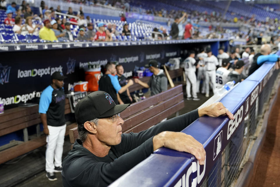 Miami Marlins manager Don Mattingly watches from the dugout before a baseball game against the Washington Nationals, Sunday, Sept. 25, 2022, in Miami. Mattingly will not be back as manager of the Miami Marlins next season. (AP Photo/Lynne Sladky)