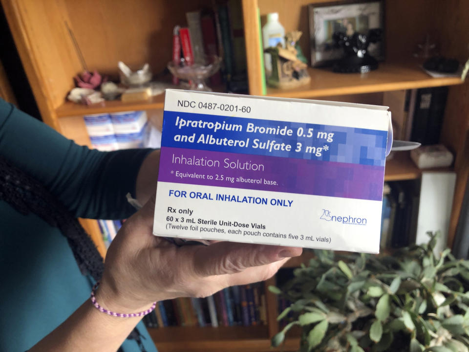 Barbara Trout, who has an asthma disorder, holds a box of inhalation solution of Ipratropium Bromide and Albuterol Sulfate, prescribed medication at her home in Keizer, Ore., Wednesday, Oct. 14, 2020. (AP Photo/Andrew Selsky)