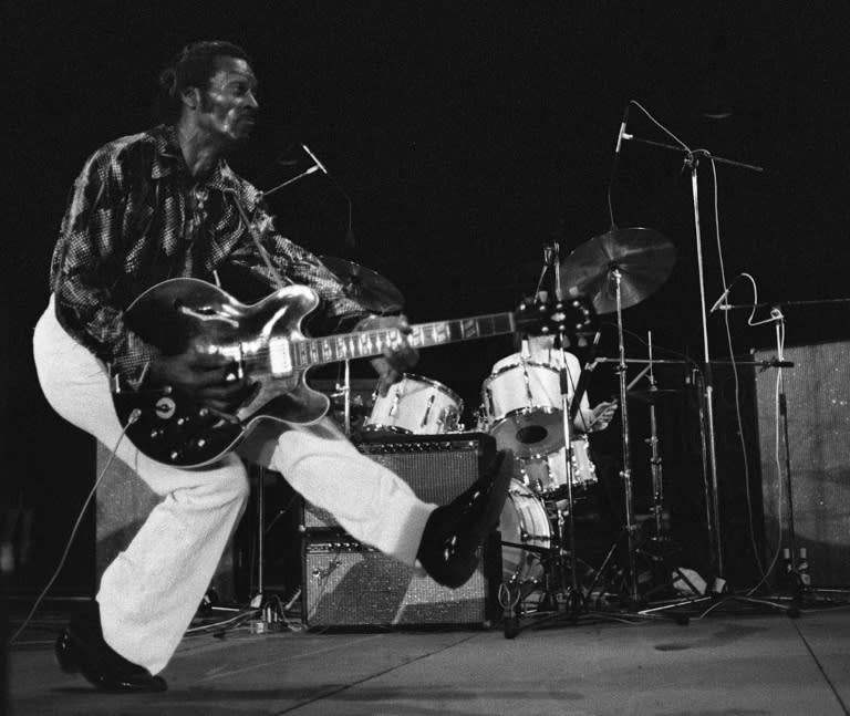 Chuck Berry produces his famous "duck walk" in front of thousands gathered to see him perform on July 10, 1981, at the old theatre in Vienne, France